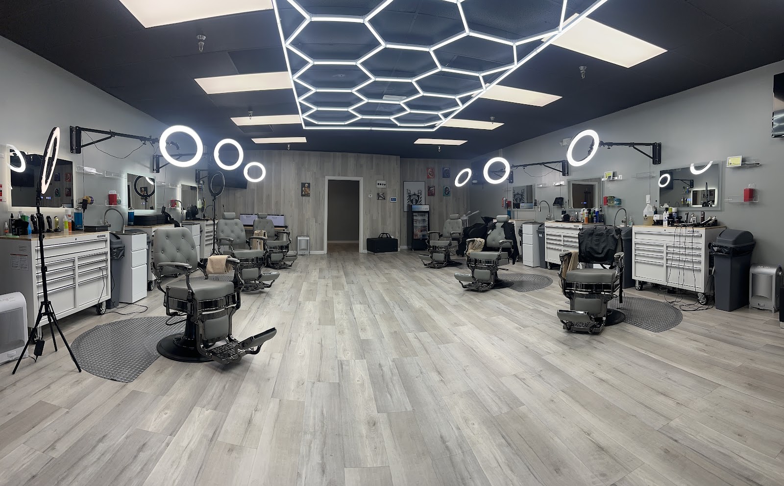 Modern barbershop interior with barber chairs and hexagon LED lighting
